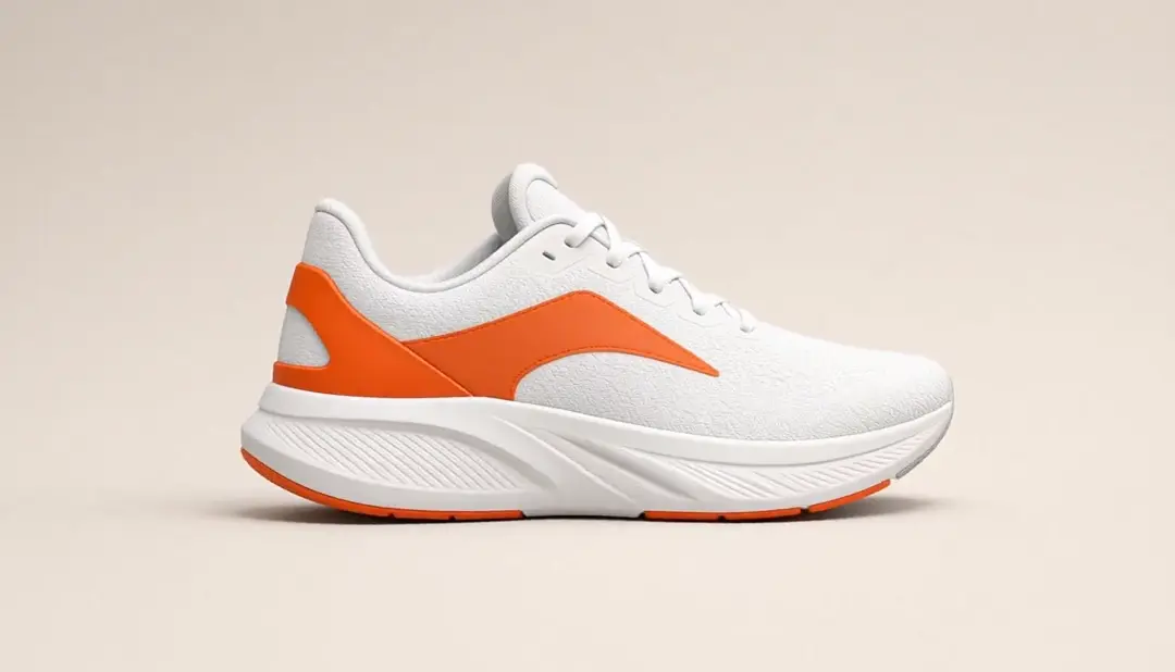 White and orange running shoe seen in side profile mid-turn on a beige background